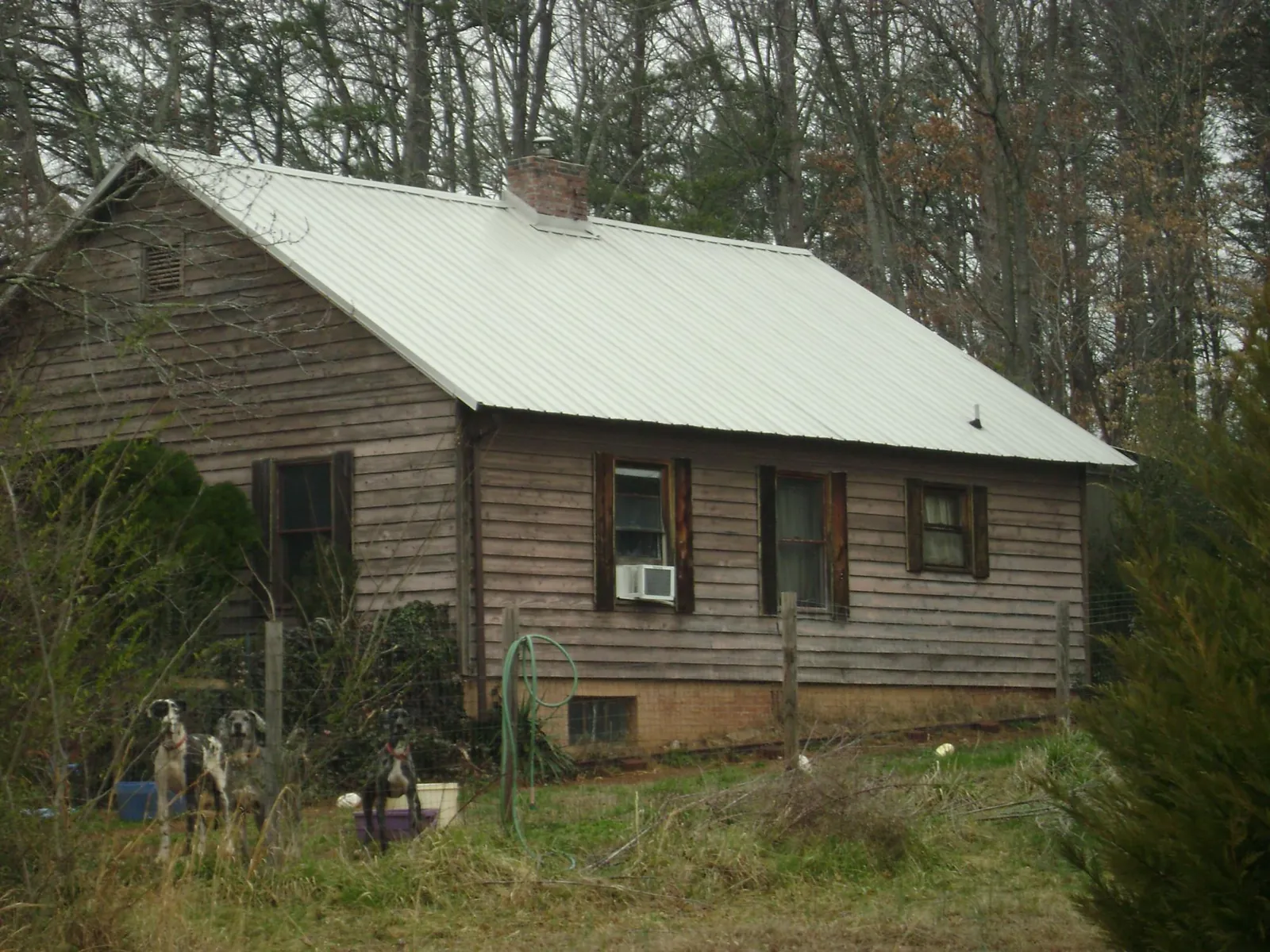 White metal roof on an old wood sided farmhouse, from a Metal Roof Installation job in Mulino